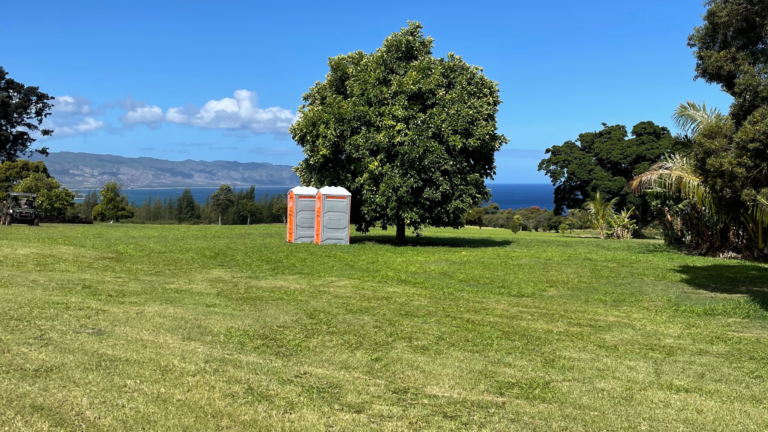 IMAGE OF JM PORTABLE RENTALS ON SITE IN THE MIDDLE OF A FIELD